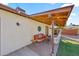 Relaxing covered patio with a comfortable seating area, hammock, and string lights for an inviting outdoor space at 14221 N 43Rd St, Phoenix, AZ 85032