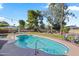 Sparkling pool surrounded by lush landscaping, shaded seating, and a swing set for outdoor fun at 14221 N 43Rd St, Phoenix, AZ 85032