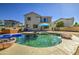Stunning backyard pool with a hot tub and an umbrella in a low-maintenance backyard at 14719 N 176Th Ave, Surprise, AZ 85388