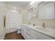 Bathroom featuring double sinks, granite countertops, framed mirrors, and a shower with a floral curtain at 14719 N 176Th Ave, Surprise, AZ 85388