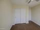 Bright bedroom features two closets, neutral colored walls and dark wood flooring at 14719 N 176Th Ave, Surprise, AZ 85388