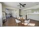 Open-concept dining and kitchen area with wood floors, neutral walls, and lots of light at 14719 N 176Th Ave, Surprise, AZ 85388