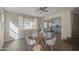 Dining area featuring wood floors, neutral walls, and bright light streaming through the large windows at 14719 N 176Th Ave, Surprise, AZ 85388