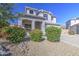 Attractive two-story home featuring a three-car garage, arched entryway, and colorful landscaping at 14719 N 176Th Ave, Surprise, AZ 85388