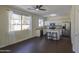 Bright kitchen with white cabinets, stainless steel appliances, island with barstools, and wood floors at 14719 N 176Th Ave, Surprise, AZ 85388