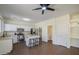 The spacious kitchen features stainless steel appliances, white cabinetry, and a center island with bar stool seating at 14719 N 176Th Ave, Surprise, AZ 85388