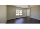 A large, well-lit bedroom features wood-look flooring, large windows, and an attached ensuite at 14719 N 176Th Ave, Surprise, AZ 85388