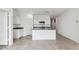 Bright, open kitchen showcasing white cabinets, granite counters, tile flooring, and an eat-in island at 1528 E Mason Dr, Casa Grande, AZ 85122