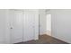 Bedroom with sliding door closet, white doors and trim, neutral carpet, and view to the hallway at 1534 E Mason Dr, Casa Grande, AZ 85122