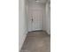 Neutral hallway features tile flooring and a white front door at 1534 E Mason Dr, Casa Grande, AZ 85122