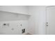 A simple laundry room with white walls and a shelf above the washer and dryer hookups at 1534 E Mason Dr, Casa Grande, AZ 85122