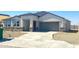 Charming single-story home with a stone facade, two-car garage, and a well-maintained desert landscape at 1540 E Mason Dr, Casa Grande, AZ 85122