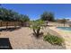 Lush backyard with a pool and desert landscaping at 15656 W Desert Mirage Dr, Surprise, AZ 85379