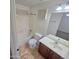 Cozy bathroom features a tub with shower, toilet, vanity sink, and a large framed mirror at 15656 W Desert Mirage Dr, Surprise, AZ 85379