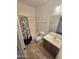 This bathroom features a shower-tub combo with a decorative shower curtain, a toilet, and a sink with a vanity at 15656 W Desert Mirage Dr, Surprise, AZ 85379