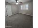 Spacious bedroom features a ceiling fan, a large window for lots of natural light, and carpeted floors at 15656 W Desert Mirage Dr, Surprise, AZ 85379