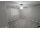 Comfortable bedroom featuring a ceiling fan, a window, and carpeted floors at 15656 W Desert Mirage Dr, Surprise, AZ 85379