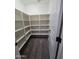 Bright walk-in closet offers lots of storage with multiple shelves for personal belongings at 15656 W Desert Mirage Dr, Surprise, AZ 85379