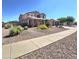 Charming two-story home with well-maintained desert landscaping and a sidewalk that leads directly to the house at 15656 W Desert Mirage Dr, Surprise, AZ 85379
