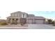 Charming two-story home features a three car garage and easy to maintain desert landscaping in front at 15656 W Desert Mirage Dr, Surprise, AZ 85379
