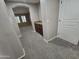 Carpeted hallway featuring a convenient built-in bar with granite countertop at 15656 W Desert Mirage Dr, Surprise, AZ 85379