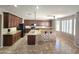 Bright and airy kitchen with granite countertops, dark cabinets, large island and ample natural light at 15656 W Desert Mirage Dr, Surprise, AZ 85379