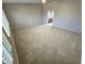 Spacious carpeted living room with tall ceilings and a ceiling fan at 15656 W Desert Mirage Dr, Surprise, AZ 85379