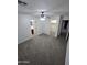 Carpeted main bedroom leading to a bathroom and walk-in closet at 15656 W Desert Mirage Dr, Surprise, AZ 85379