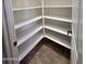 Spacious walk-in pantry features ample shelving for organized storage of food and kitchen essentials at 15656 W Desert Mirage Dr, Surprise, AZ 85379
