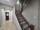 Carpeted staircase with decorative iron railings and wood accents creates a visually appealing transition between floors at 15656 W Desert Mirage Dr, Surprise, AZ 85379
