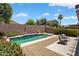 A private backyard with a swimming pool, desert landscaping, and privacy wall at 15790 W Arrowhead Dr, Surprise, AZ 85374