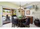 Stylish dining room with a contemporary chandelier, a large dining table and access to the backyard at 15790 W Arrowhead Dr, Surprise, AZ 85374