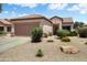 Charming single-story home featuring a two-car garage and low-maintenance desert landscaping at 15790 W Arrowhead Dr, Surprise, AZ 85374