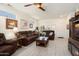 Open living room with hardwood floors, decorative ceiling fan and modern design elements at 15790 W Arrowhead Dr, Surprise, AZ 85374