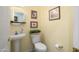 Well-lit powder room features a pedestal sink, decorative mirror, and neutral wall color at 15790 W Arrowhead Dr, Surprise, AZ 85374