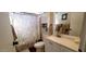 Charming bathroom featuring a vanity with counter space, cabinet, and a patterned shower curtain at 17200 W Bell Rd # 1622, Surprise, AZ 85374
