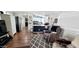 Open living room flowing into the kitchen, featuring hardwood floors and a comfortable recliner at 17200 W Bell Rd # 1622, Surprise, AZ 85374