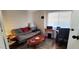 Cozy living room featuring a futon sofa bed, a wood coffee table, and a dedicated work space at 17200 W Bell Rd # 1622, Surprise, AZ 85374