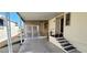 Covered patio with pavers, and a white metal railing and stairs that lead to the entrance at 17200 W Bell Rd # 1622, Surprise, AZ 85374