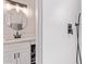 Stylish bathroom featuring modern fixtures, a frameless round mirror, and sleek white tile shower at 1809 S Heritage --, Mesa, AZ 85210