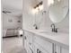Modern bathroom features double sinks with white cabinetry and black fixtures, complemented by stylish lighting at 1809 S Heritage --, Mesa, AZ 85210