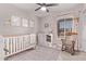 Charming Bedroom with a modern crib, stylish dresser, and a cozy rocking chair, perfect for a growing Gathering at 1809 S Heritage --, Mesa, AZ 85210