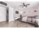 Cozy bedroom is equipped with ceiling fan, TV, decorative lighting, and features seamless access to closet at 1809 S Heritage --, Mesa, AZ 85210