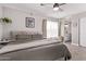 Comfortable bedroom boasts a ceiling fan, soft lighting, and an ensuite bathroom for added privacy at 1809 S Heritage --, Mesa, AZ 85210