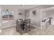 Light-filled dining room features a modern table, stylish chairs, and access to the kitchen bar area at 1809 S Heritage --, Mesa, AZ 85210