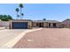 Single-story home featuring mature palm trees and a low-maintenance desert landscape at 1809 S Heritage --, Mesa, AZ 85210