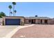 Charming single-story home featuring mature palm trees and a low-maintenance desert landscape at 1809 S Heritage --, Mesa, AZ 85210
