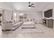 Bright and inviting living room featuring a plush sectional sofa, ceiling fan and modern decor at 1809 S Heritage --, Mesa, AZ 85210