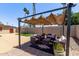 Inviting patio area with comfortable seating, a stylish pergola, and lush landscaping, perfect for outdoor gatherings at 1809 S Heritage --, Mesa, AZ 85210