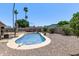 Refreshing pool in the backyard with surrounding trees and gravel, perfect for enjoying sunny days at 1809 S Heritage --, Mesa, AZ 85210